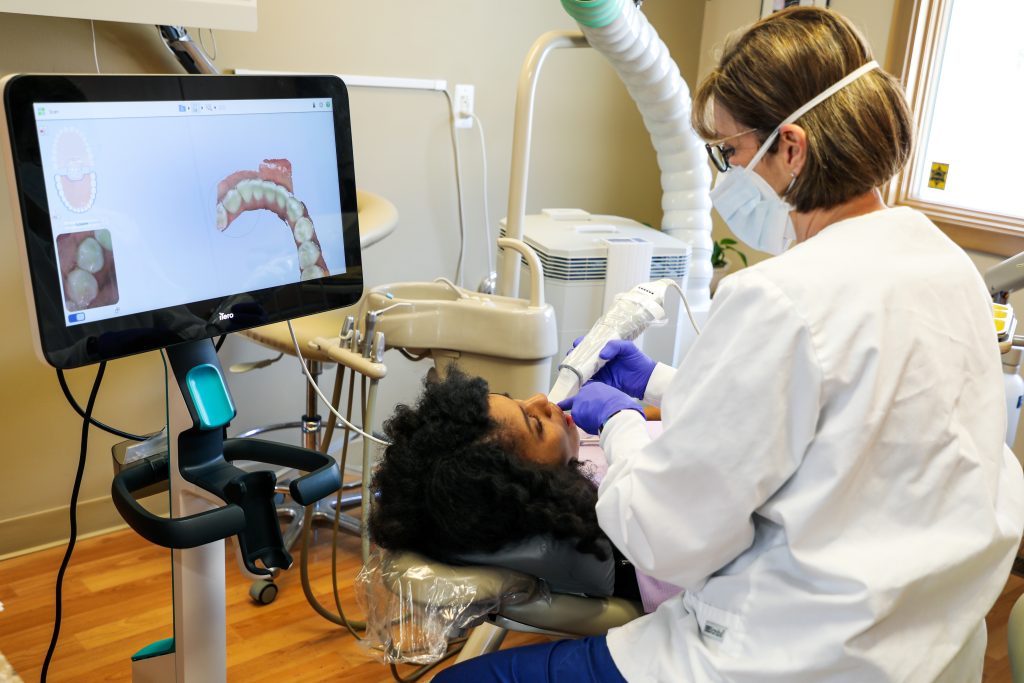 Dental assistant reviewing a scan with a patient at David Schmidt, DDS