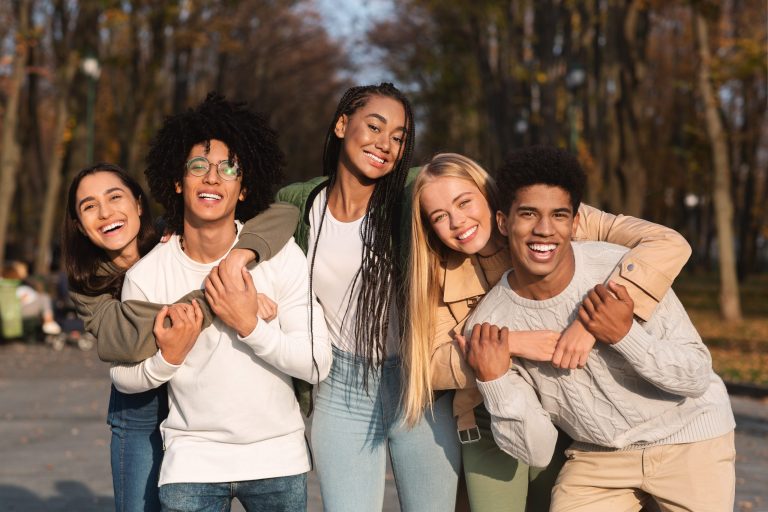 Group of smiling young adults with healthy smiles