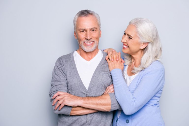 Smiling older couple, patients keeping healthy teeth into later life